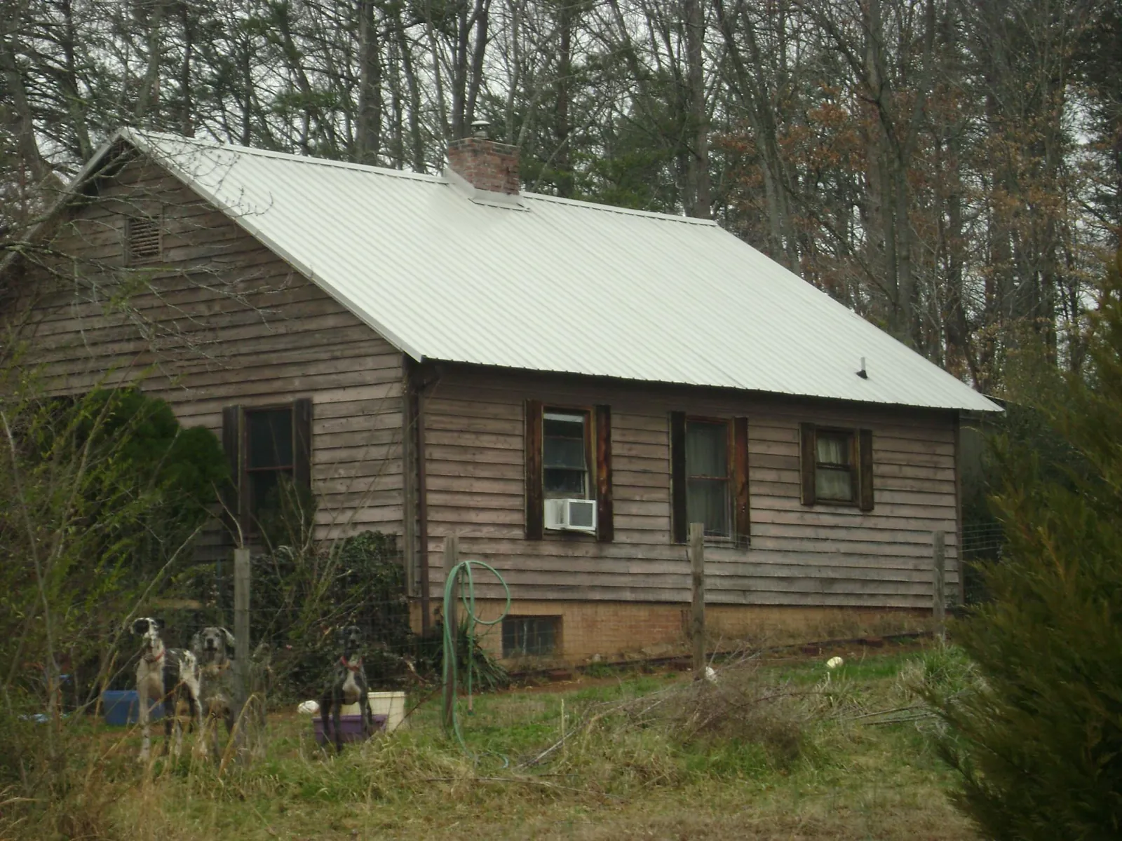 White metal roof on an old wood sided farmhouse, from a Metal Roof Installation job in Kennerdell